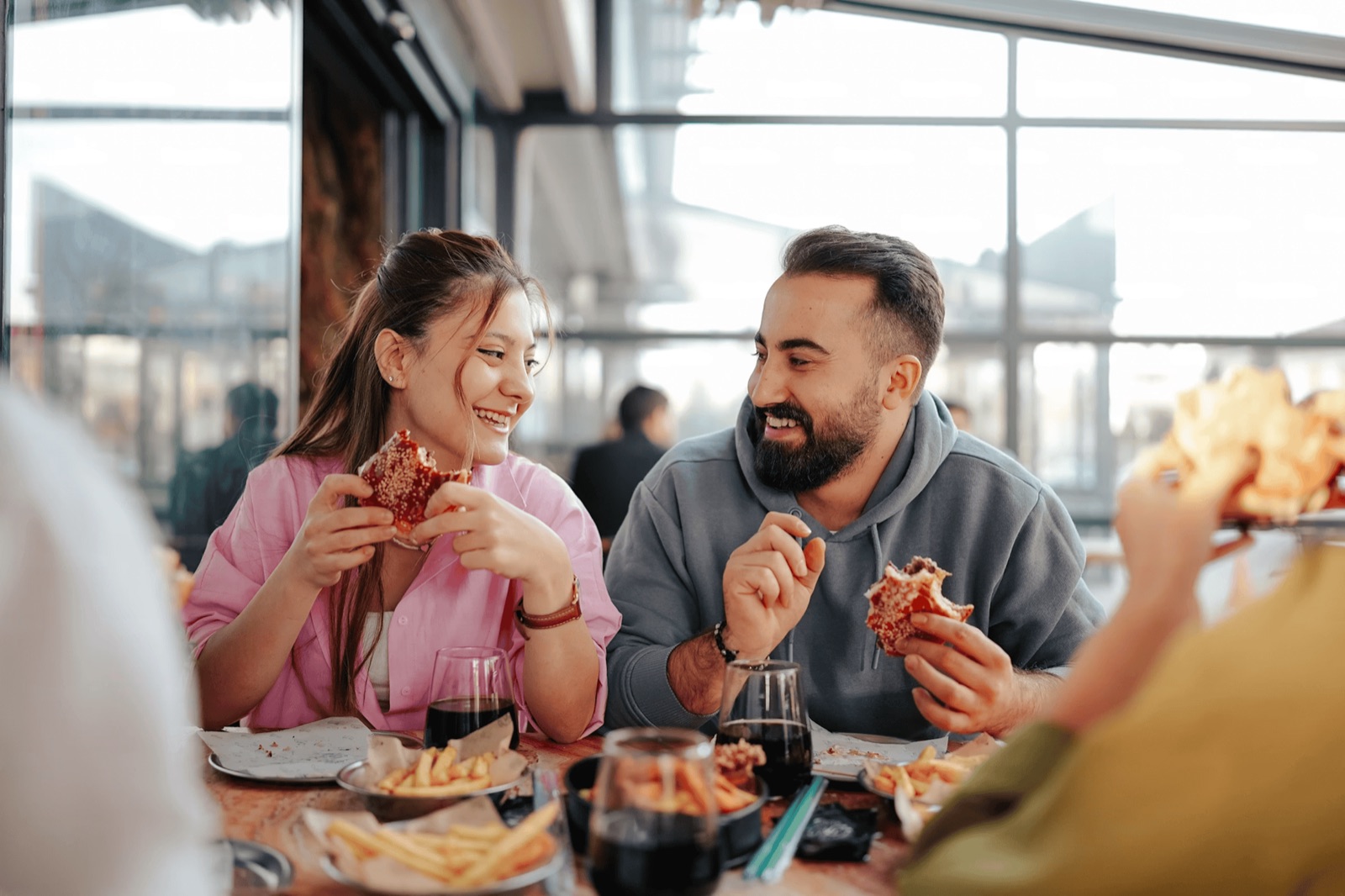 A family laughing together over pizza at their neighborhood restaurant